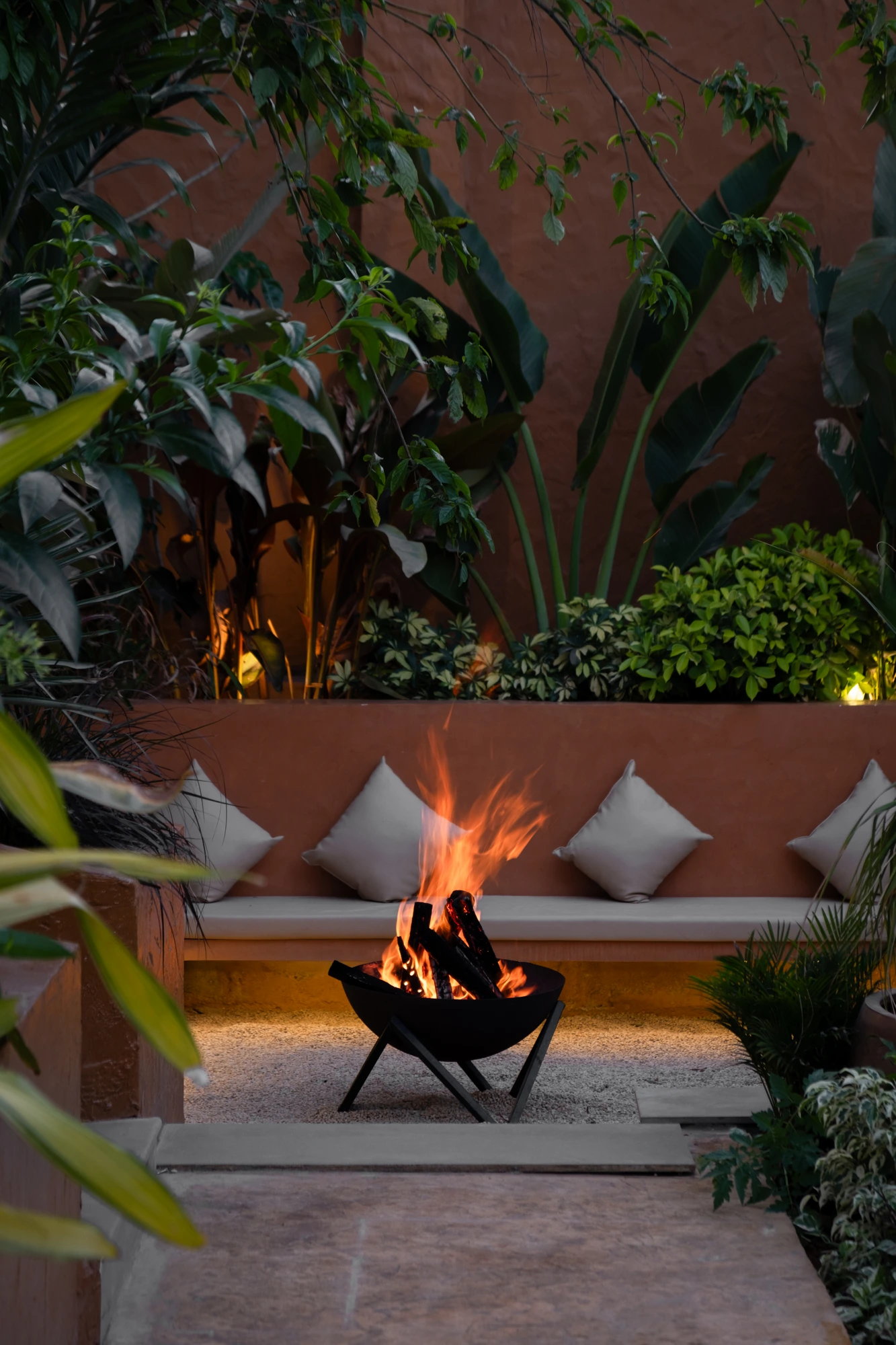 A bonfire corner among plants at Dune Villas at night