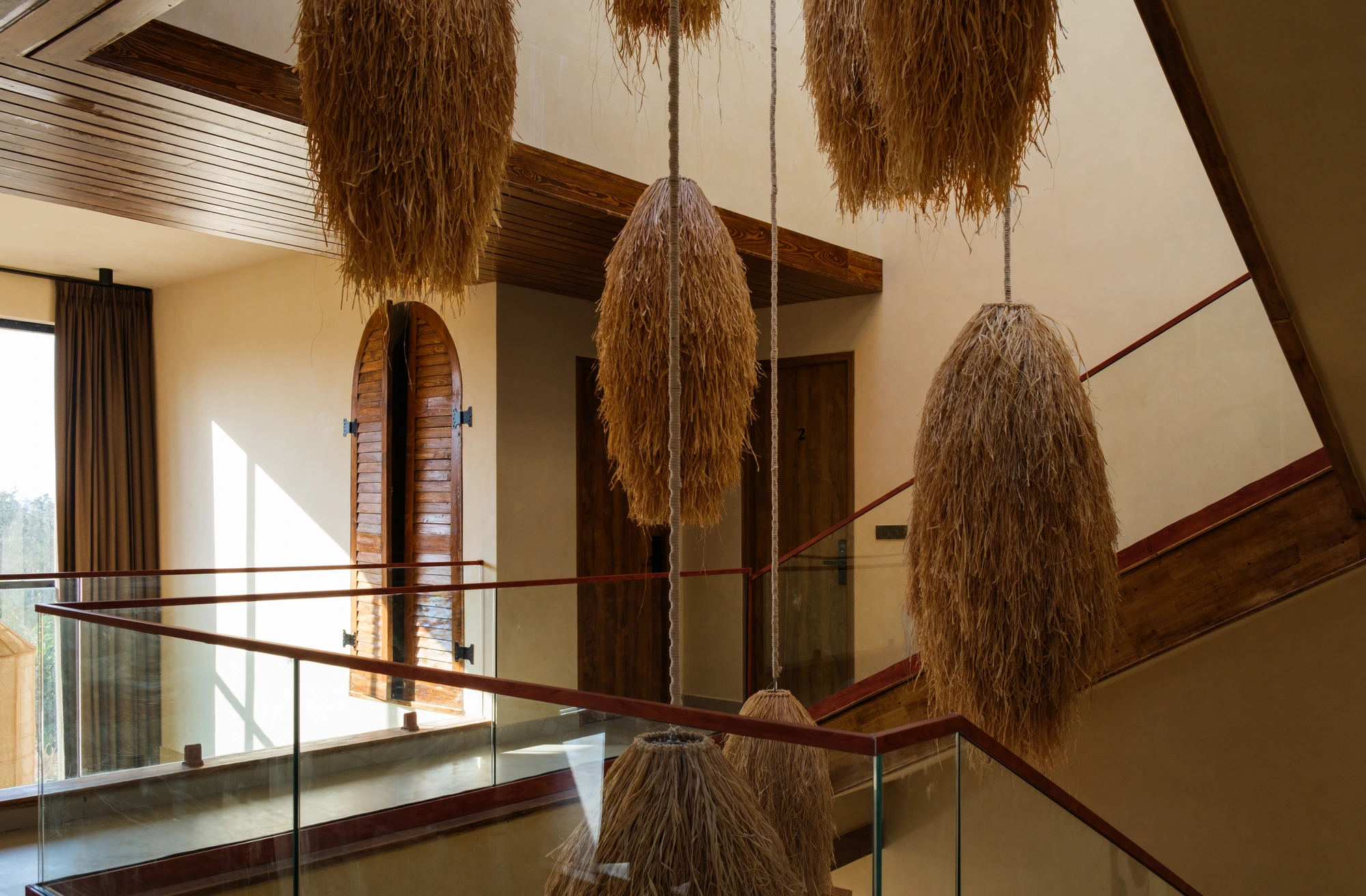Woven pendants hanging above the staircase of a Dune Villa